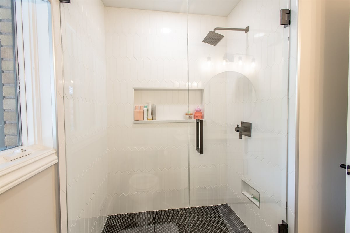 walk-in-shower-with-white-subway-tile-a-niche-and-a-window-southeast-mi-optimized