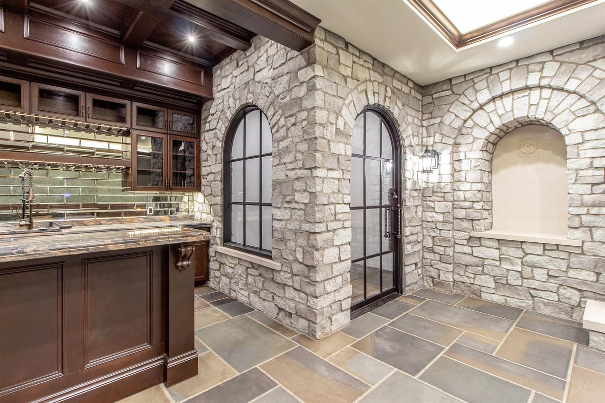 basement-bar-with-stone-arches-and-an-iron-and-glass-door-southeast-mi-optimized