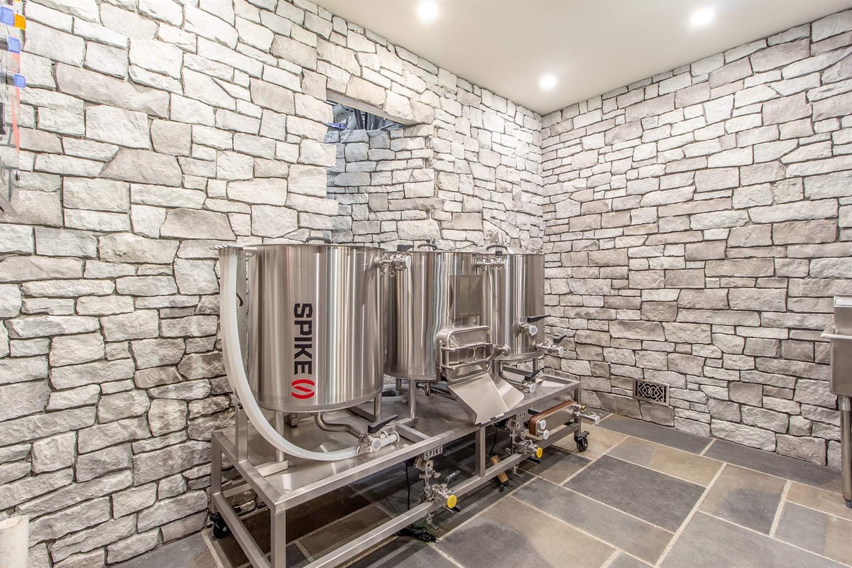 close-view-of-stainless-brewing-tanks-against-a-stone-wall-southeast-mi-optimized