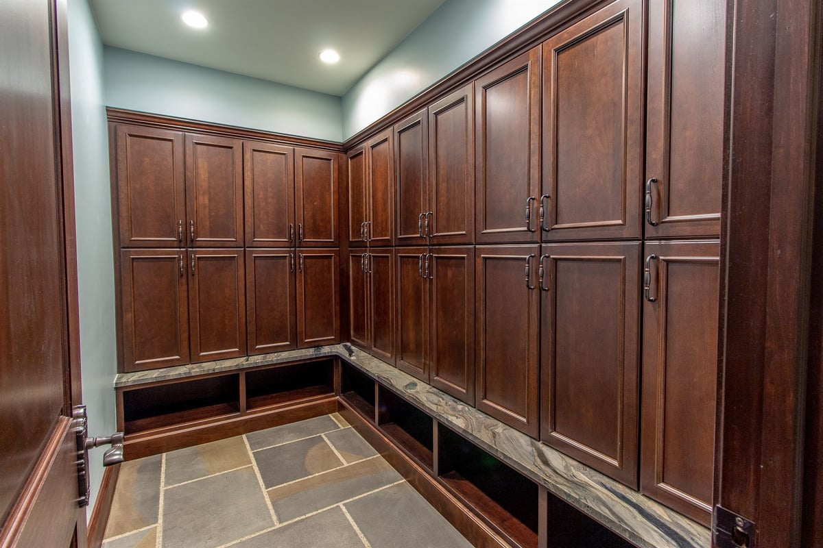 dressing-area-with-dark-wood-lockers-and-a-stone-bench-southeast-mi-optimized
