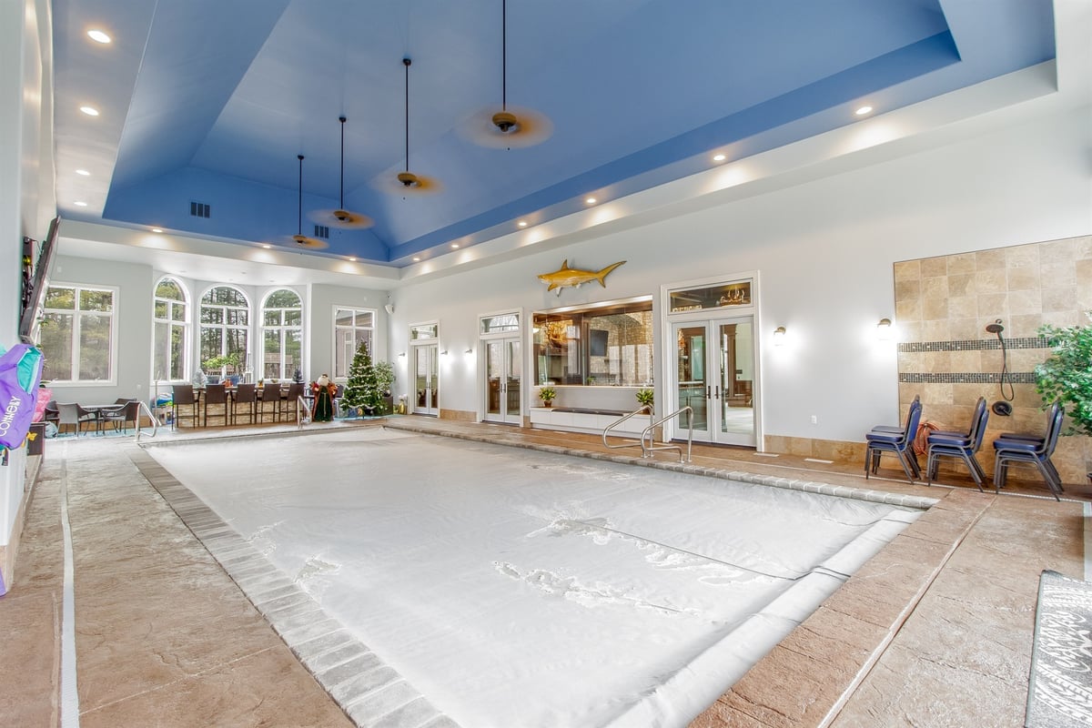 indoor-pool-room-with-a-blue-tray-ceiling-and-arched-windows-southeast-mi-optimized
