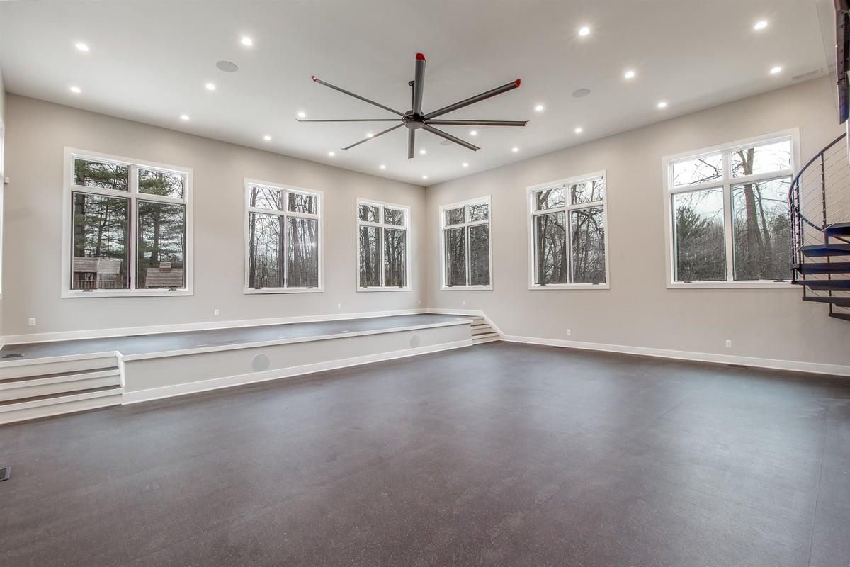 open-recreation-room-with-a-wall-of-windows-and-an-oversized-ceiling-fan-southeast-mi-optimized