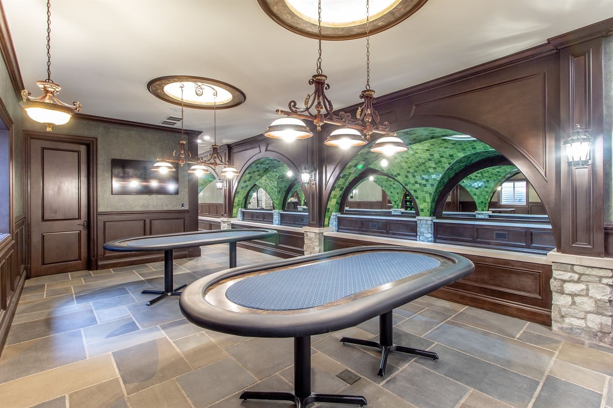 poker-room-with-an-oval-table-chandeliers-and-stone-arches-southeast-mi-optimized