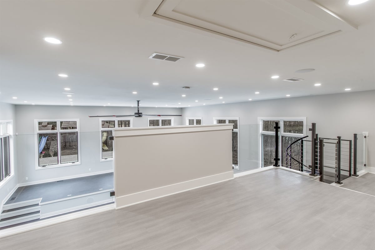 upper-loft-with-a-glass-railing-overlooking-the-lower-level-southeast-mi-optimized