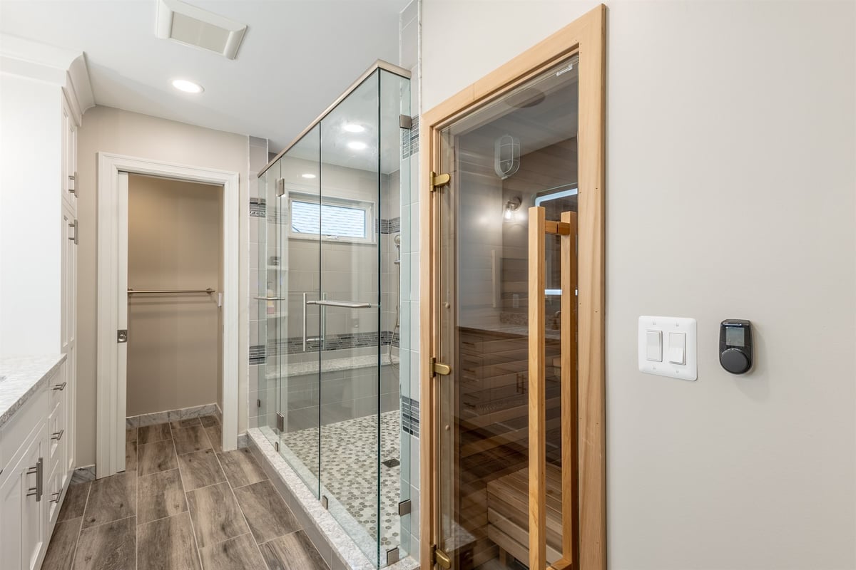 master-bath-with-a-walk-in-glass-shower-cedar-sauna-and-wood-look-tile-floor-southeast-mi-optimized