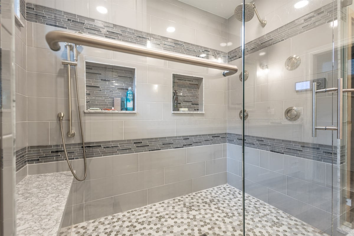 walk-in-shower-interior-with-grab-bar-niche-bench-and-hex-tile-floor-southeast-mi-optimized