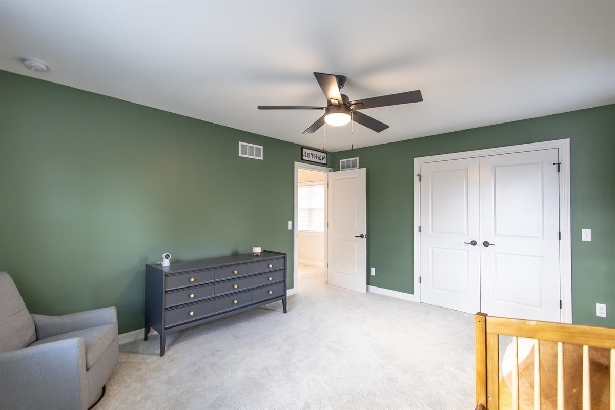 bedroom-after-renovation-with-a-green-accent-wall-and-ceiling-fan-grosse-ile-mi-optimized