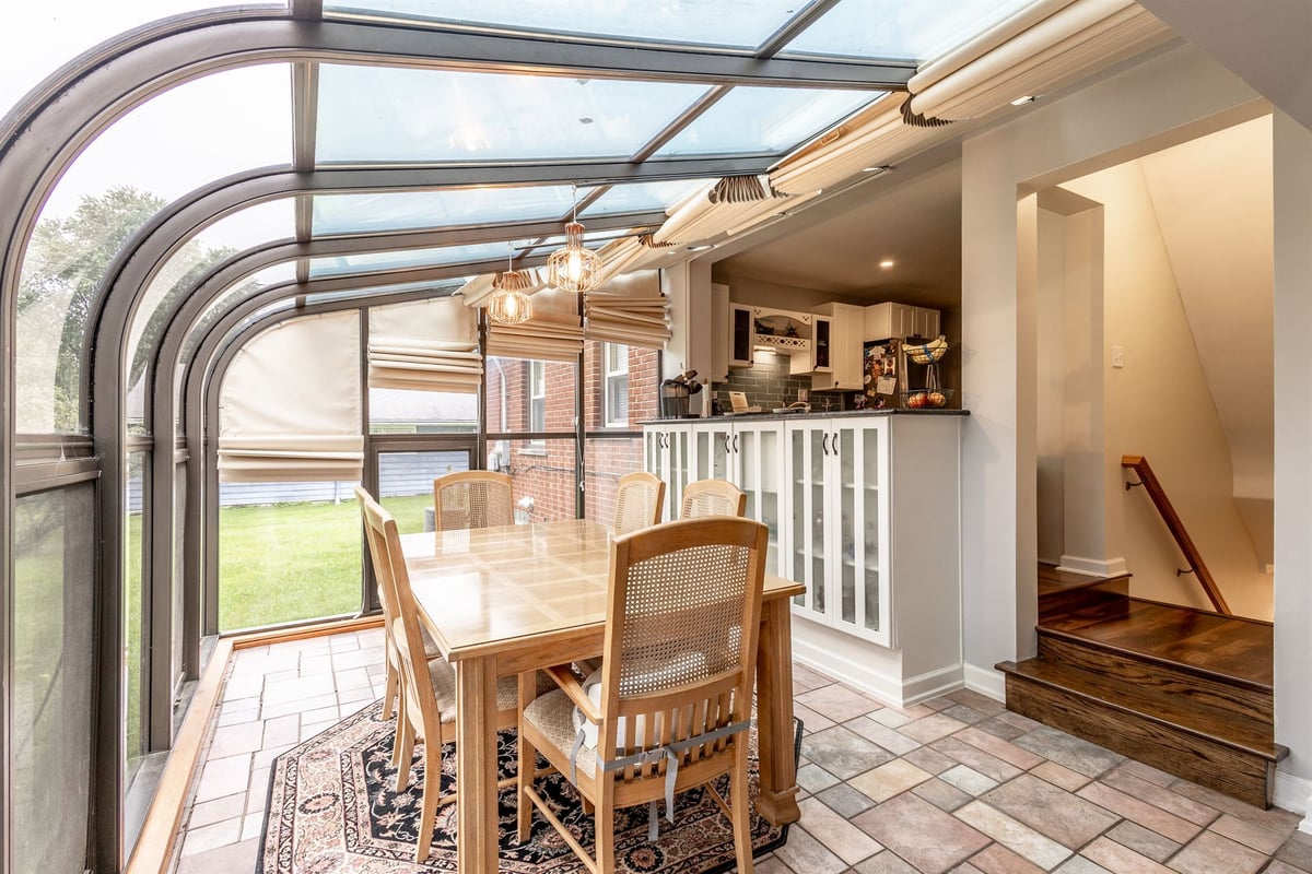 curved-glass-sunroom-renovation-with-a-dining-table-grosse-ile-mi-optimized