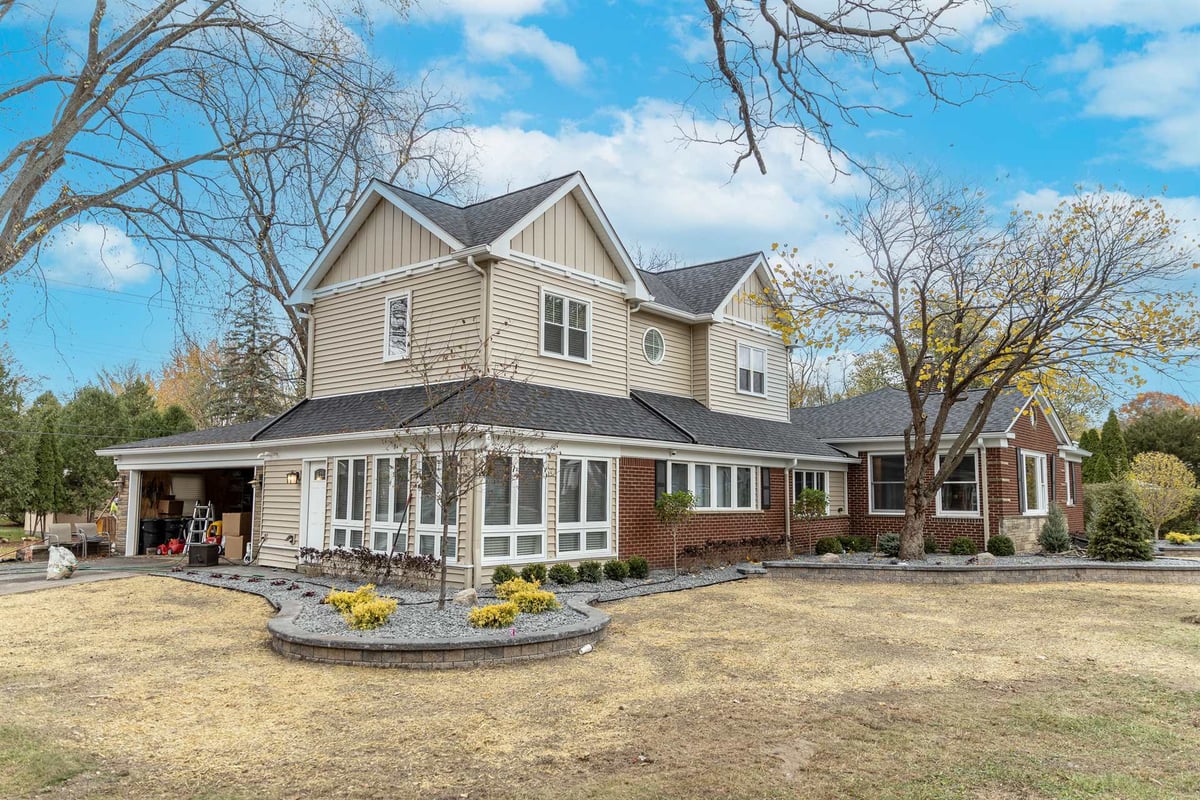 front-angle-after-renovation-with-the-two-story-addition-and-sunroom-grosse-ile-mi-optimized