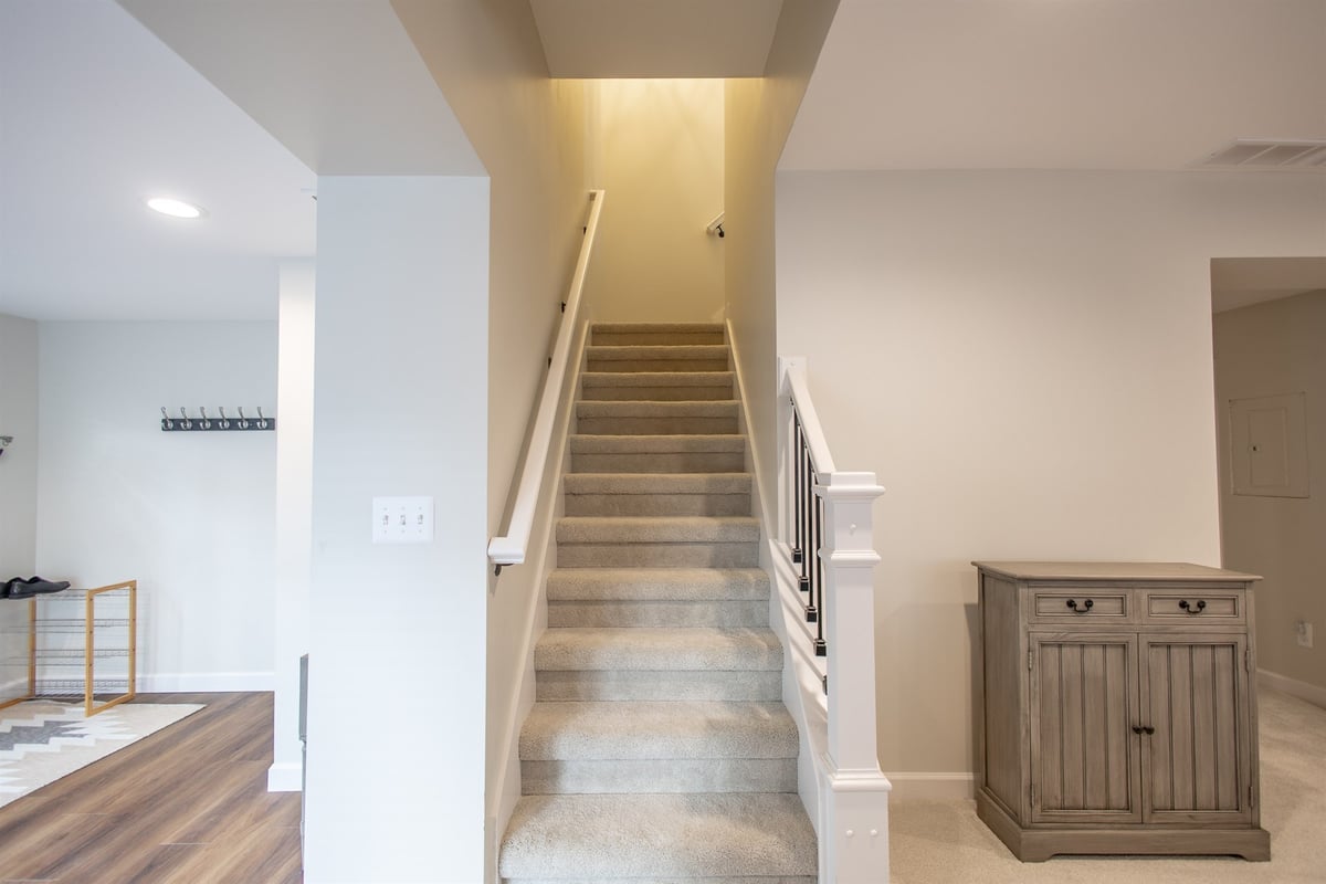 stairway-after-renovation-with-a-carpet-runner-and-wood-railing-grosse-ile-mi-optimized