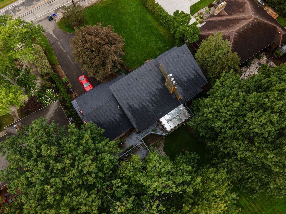aerial-roof-view-of-a-contemporary-home-with-driveway-and-surrounding-trees-southeast-mi-optimized