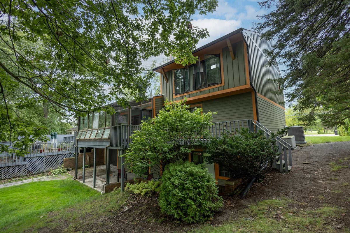rear-angle-showing-a-raised-deck-exterior-stairs-and-walkout-lower-level-southeast-mi-optimized