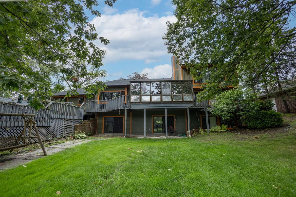 rear-elevation-with-an-elevated-deck-sunroom-and-open-backyard-southeast-mi-optimized