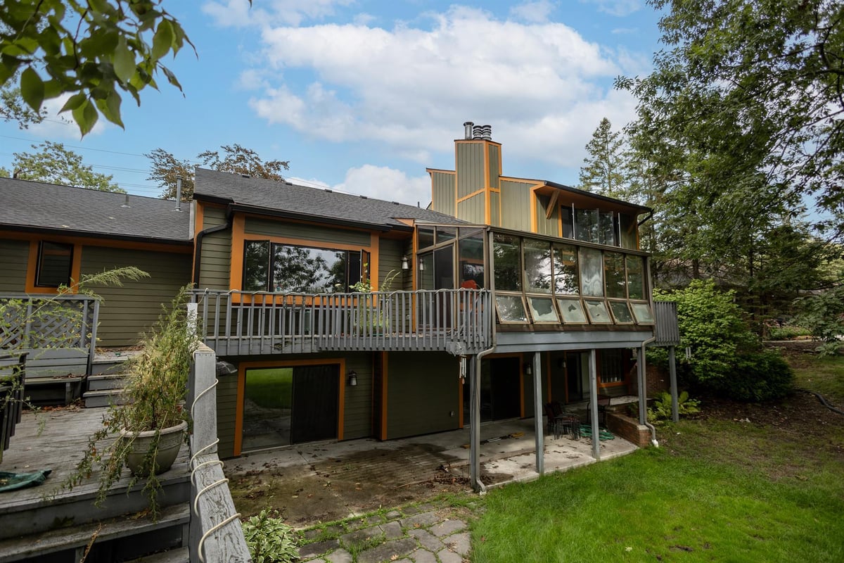 rear-view-of-an-elevated-wood-deck-with-a-glass-roof-sunroom-and-walkout-level-southeast-mi-optimized