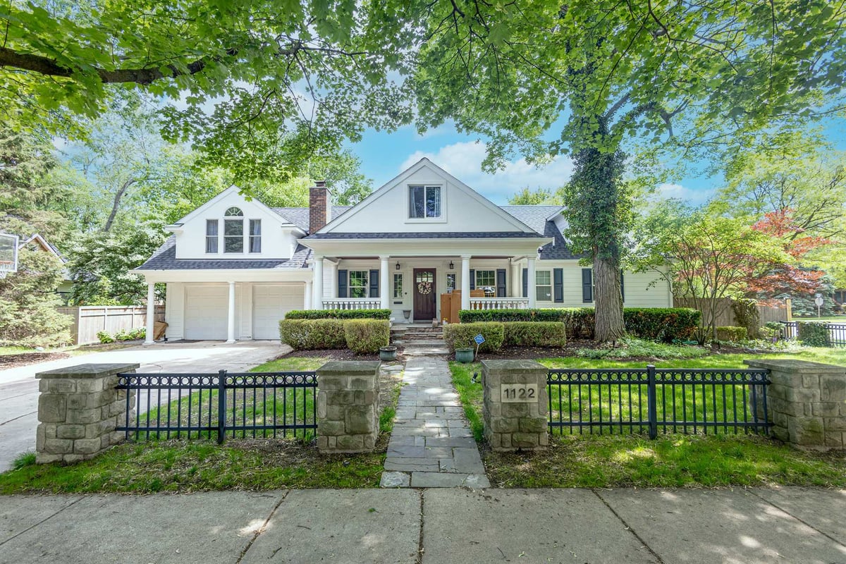 front-elevation-of-a-white-home-with-a-covered-porch-and-dormers-southeast-mi-optimized