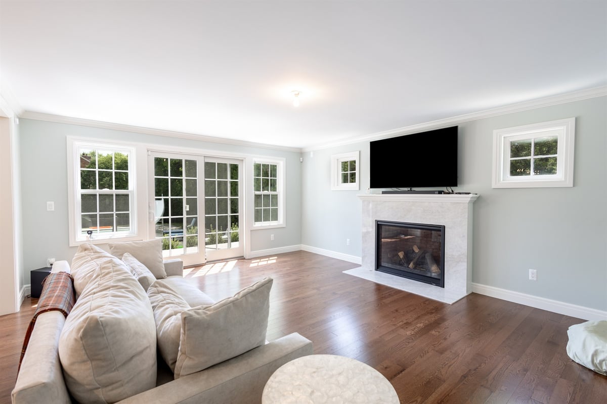 living-room-with-a-marble-fireplace-french-doors-and-hardwood-floors-southeast-mi-optimized