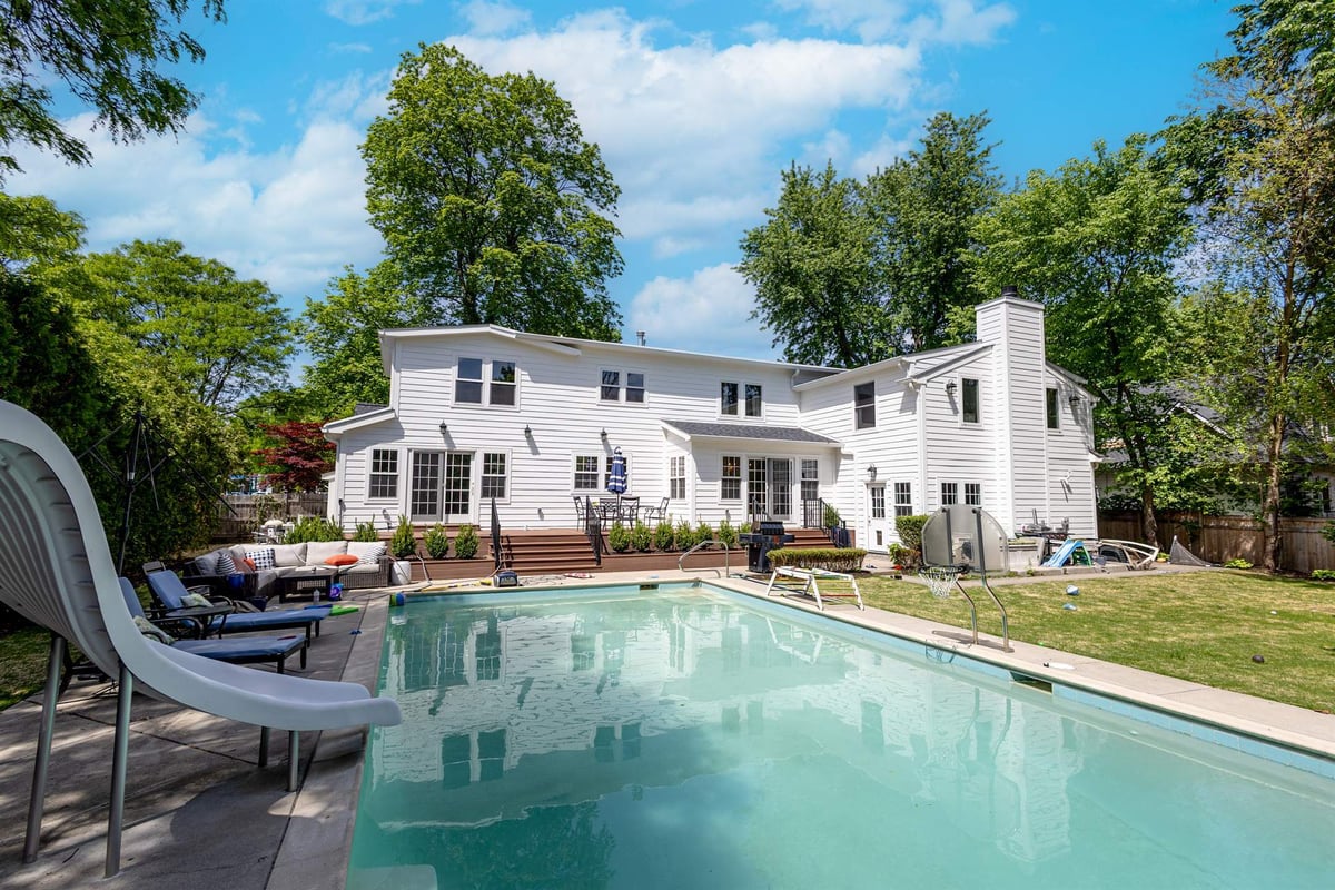 rear-exterior-with-an-in-ground-pool-wood-deck-and-lounge-area-southeast-mi-optimized