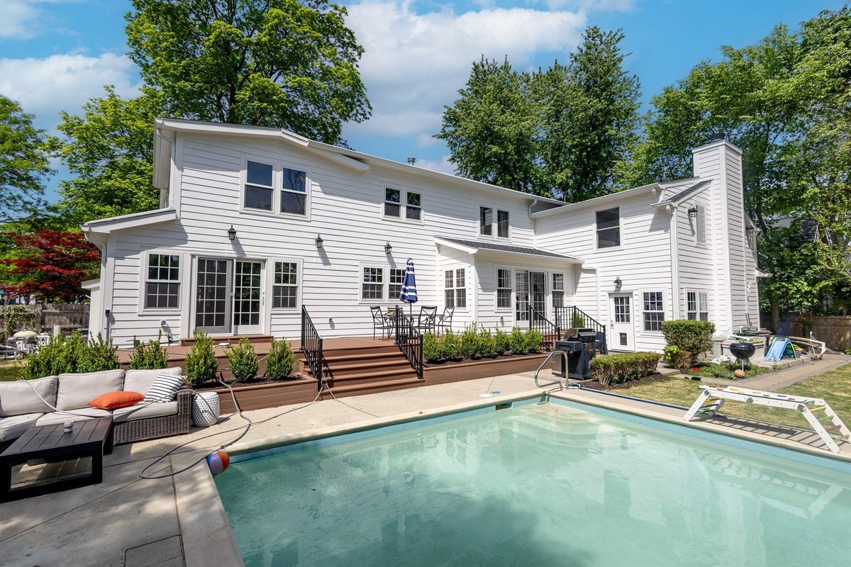 rear-yard-with-the-pool-in-the-foreground-and-a-wood-deck-southeast-mi-optimized