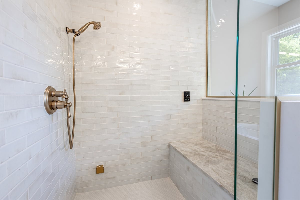 walk-in-shower-with-white-tile-a-bench-and-brushed-gold-fixtures-southeast-mi-optimized