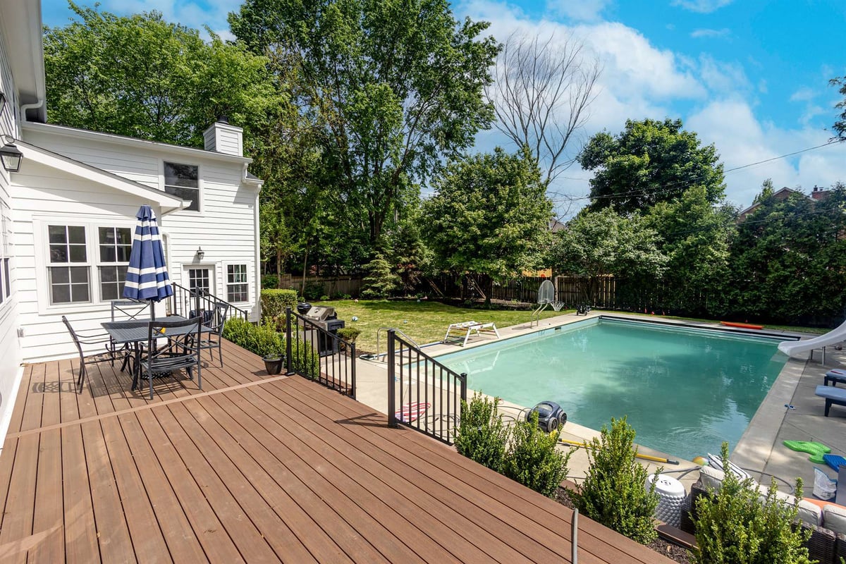 wood-deck-and-in-ground-pool-behind-a-white-two-story-home-southeast-mi-optimized