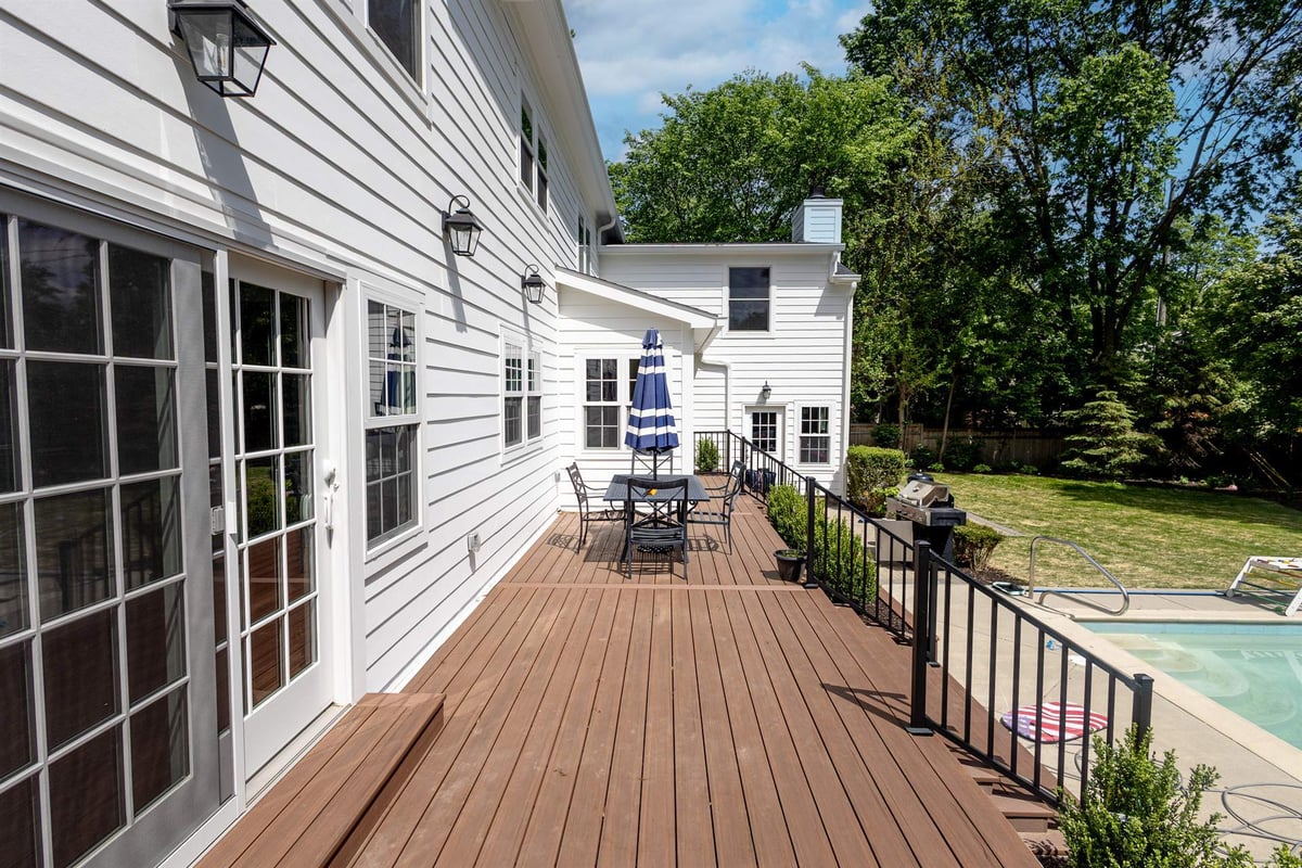 wood-deck-running-along-the-back-of-the-house-beside-the-pool-southeast-mi-optimized