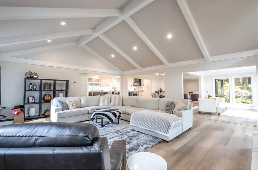 great room home addition with exposed beams and open layout