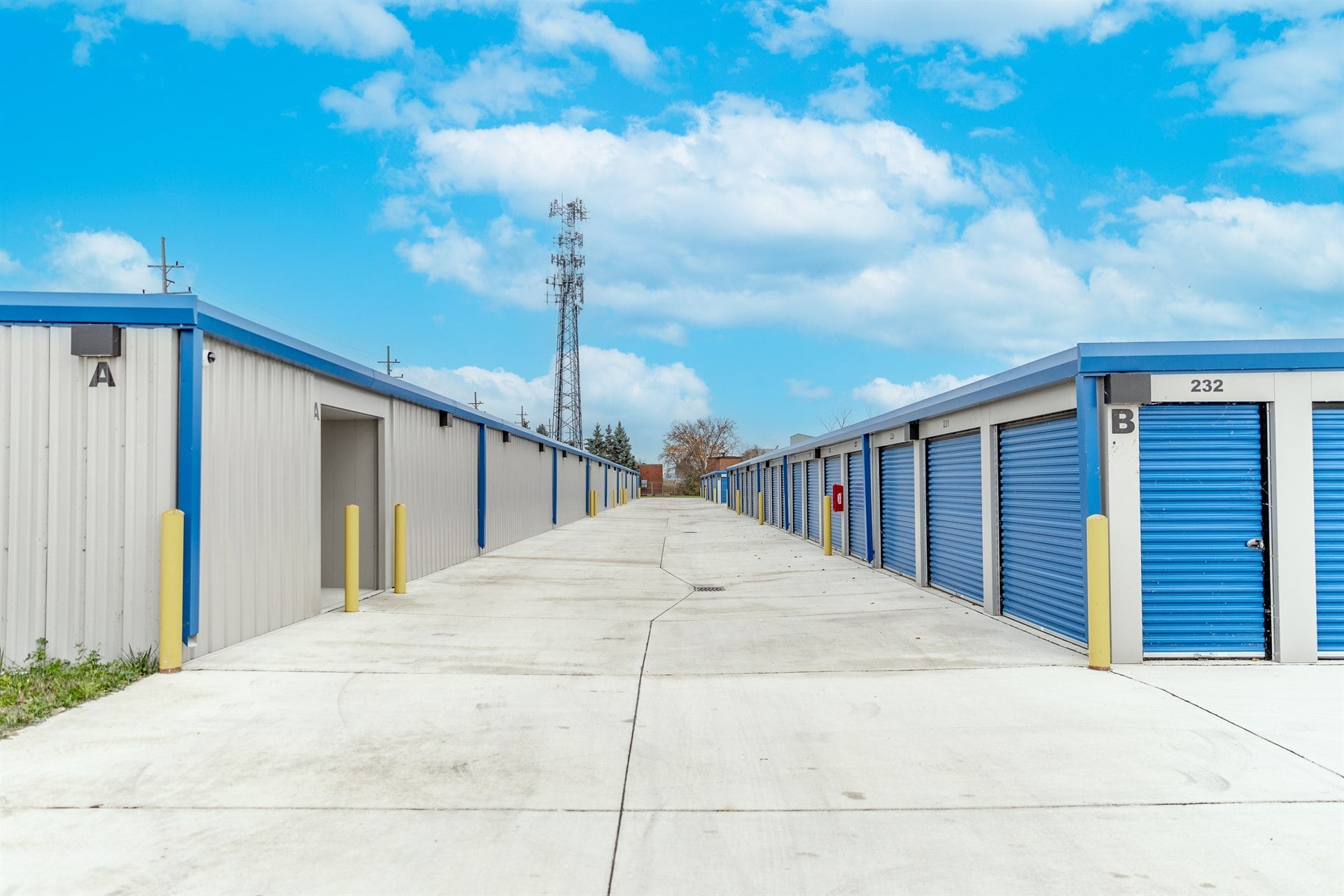 drive-lane-between-two-rows-of-blue-door-buildings-commercial-self-storage-southeast-mi-optimized