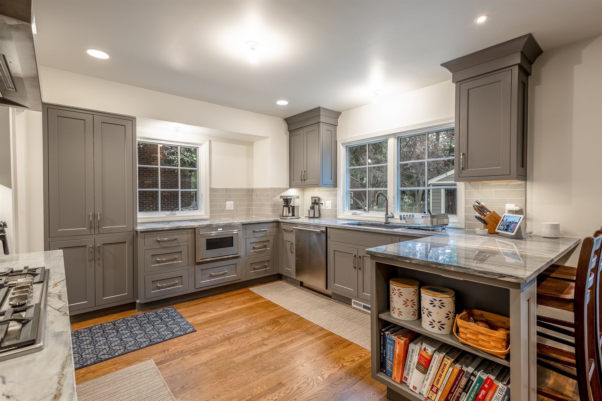 kitchen-with-gray-cabinets-quartz-counters-and-an-island-with-shelving-southeast-mi-optimized