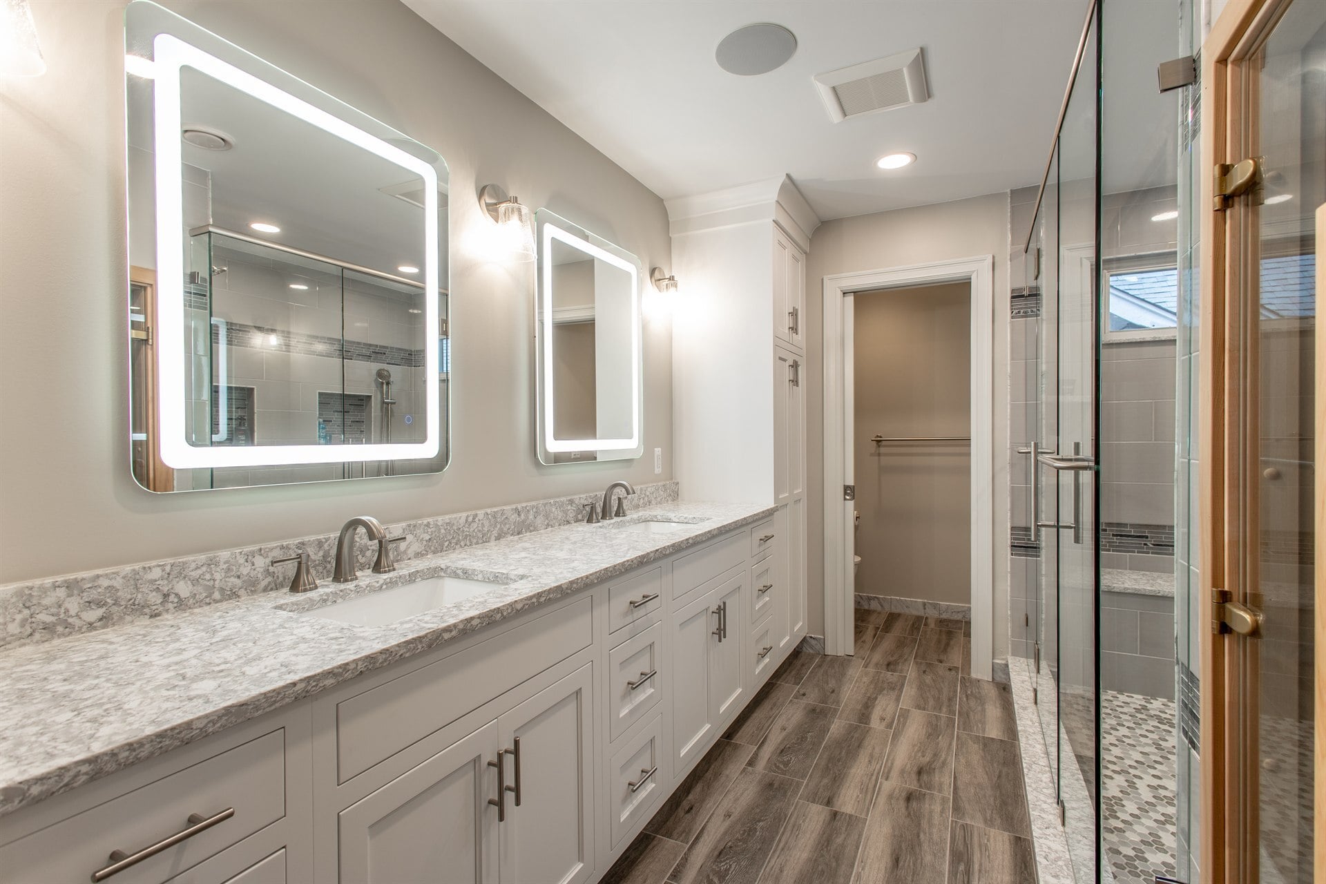 remodeled-master-bathroom-with-a-double-quartz-vanity-and-backlit-led-mirrors-southeast-mi-optimized