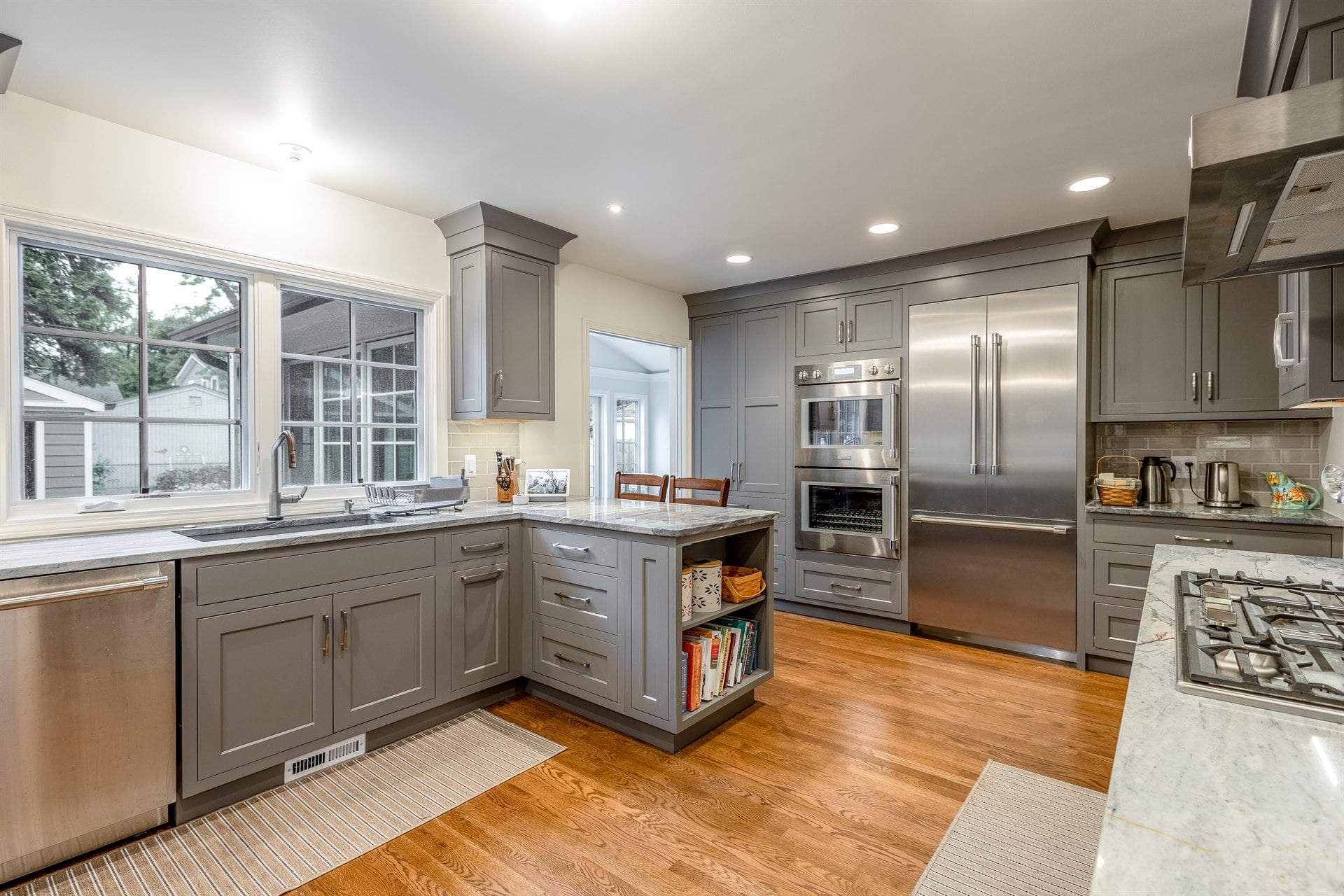 kitchen-with-a-gray-island-open-shelving-and-a-stainless-wall-oven-southeast-mi-optimized