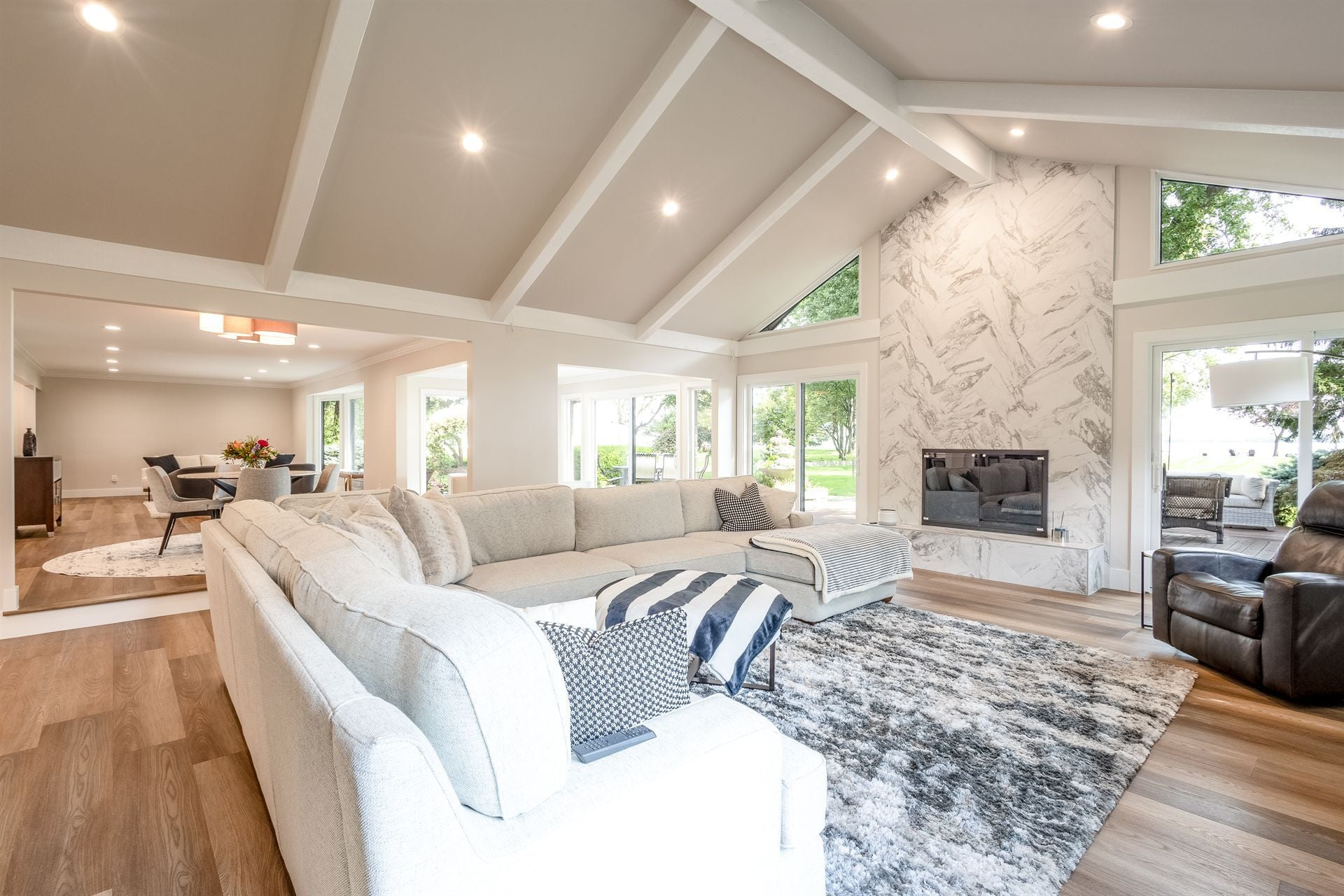 great-room-with-a-vaulted-beamed-ceiling-marble-fireplace-and-sectional-southeast-mi-optimized